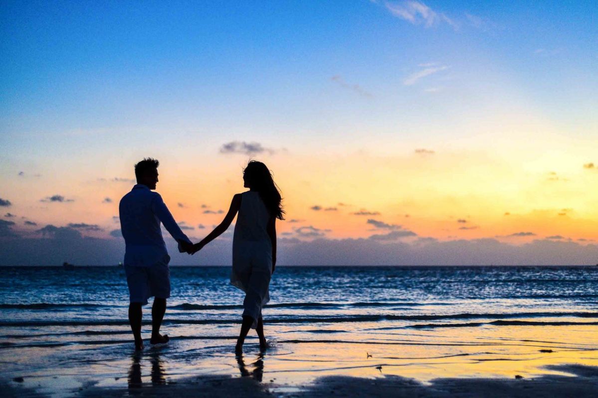 man-and-woman-holding-hands-walking-on-seashore-during-1024960-2020-02-13-10-34-large