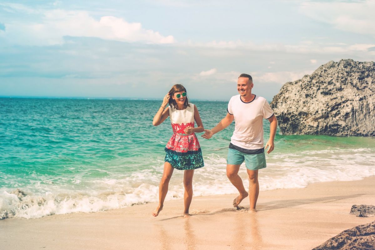 photo-of-laughing-couple-walking-by-the-beach-2383861-2020-02-10-02-43-large