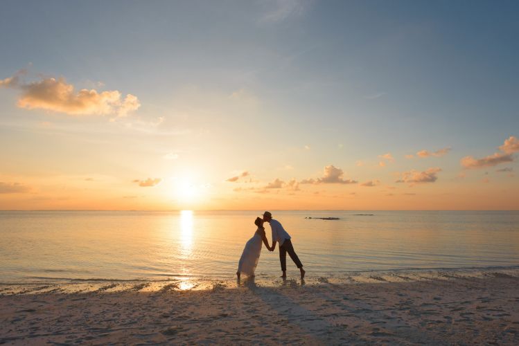 beach wedding couple kissing