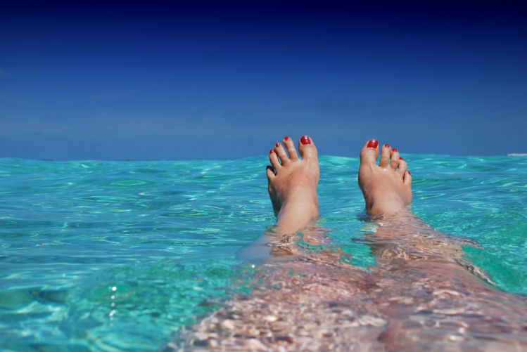 feet soak in ocean beach