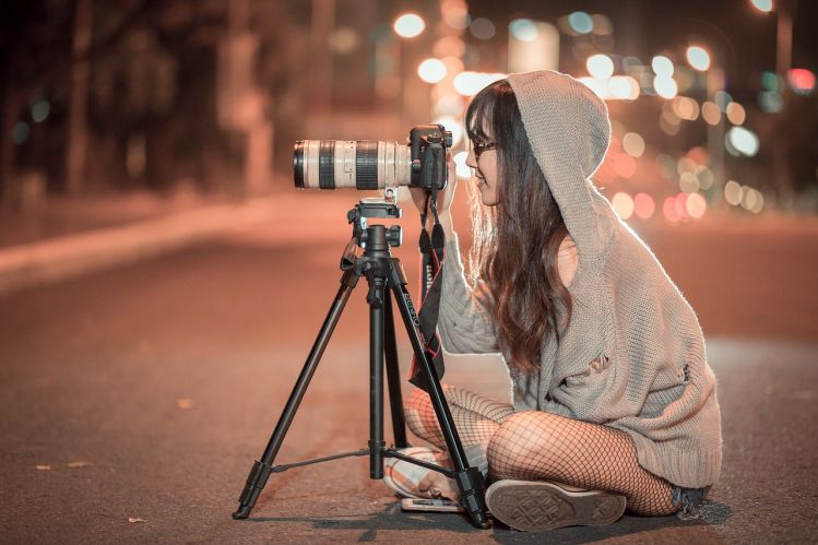 girl taking photo at night