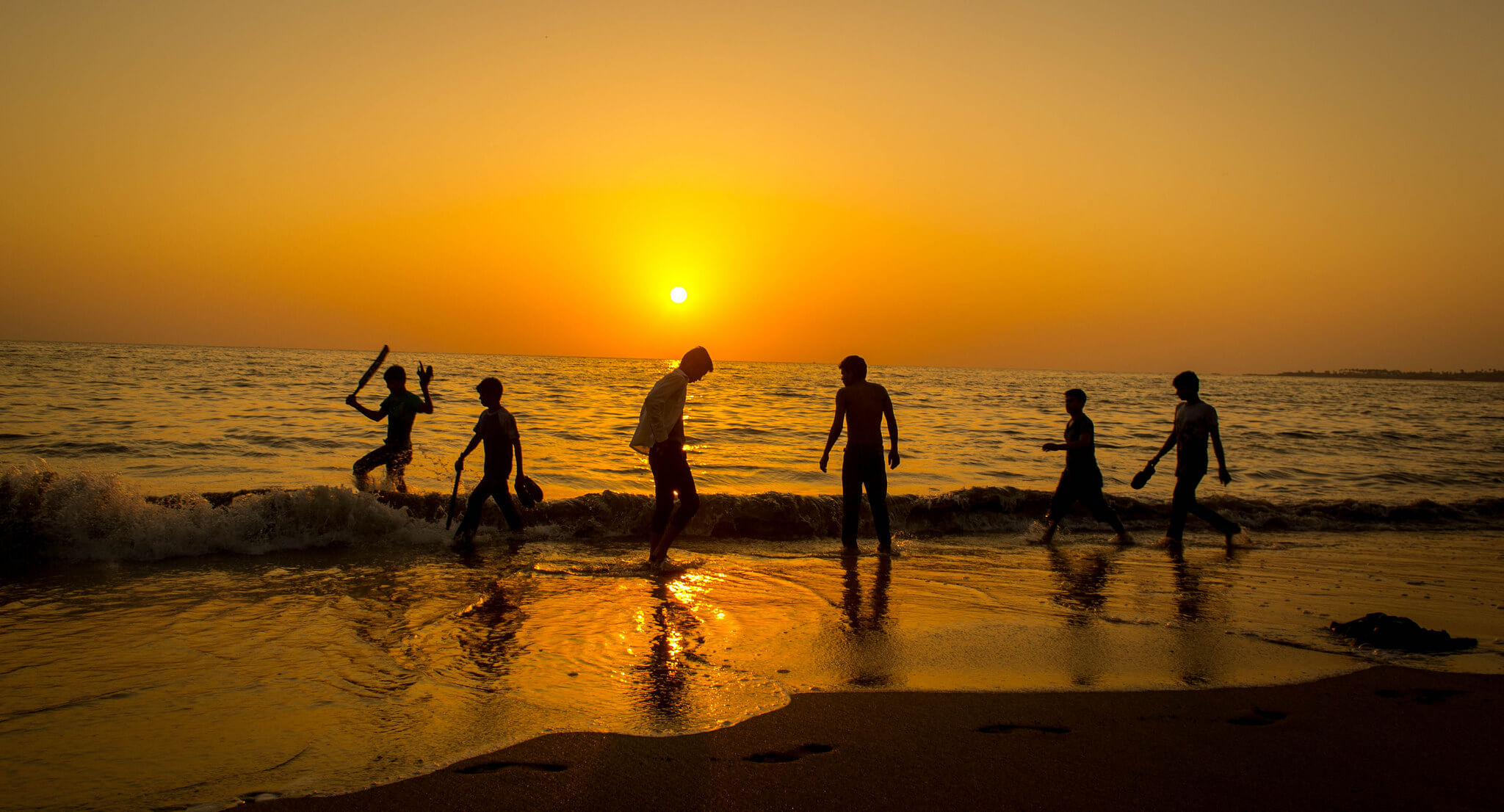 guys-enjoying-sunset-at-beach