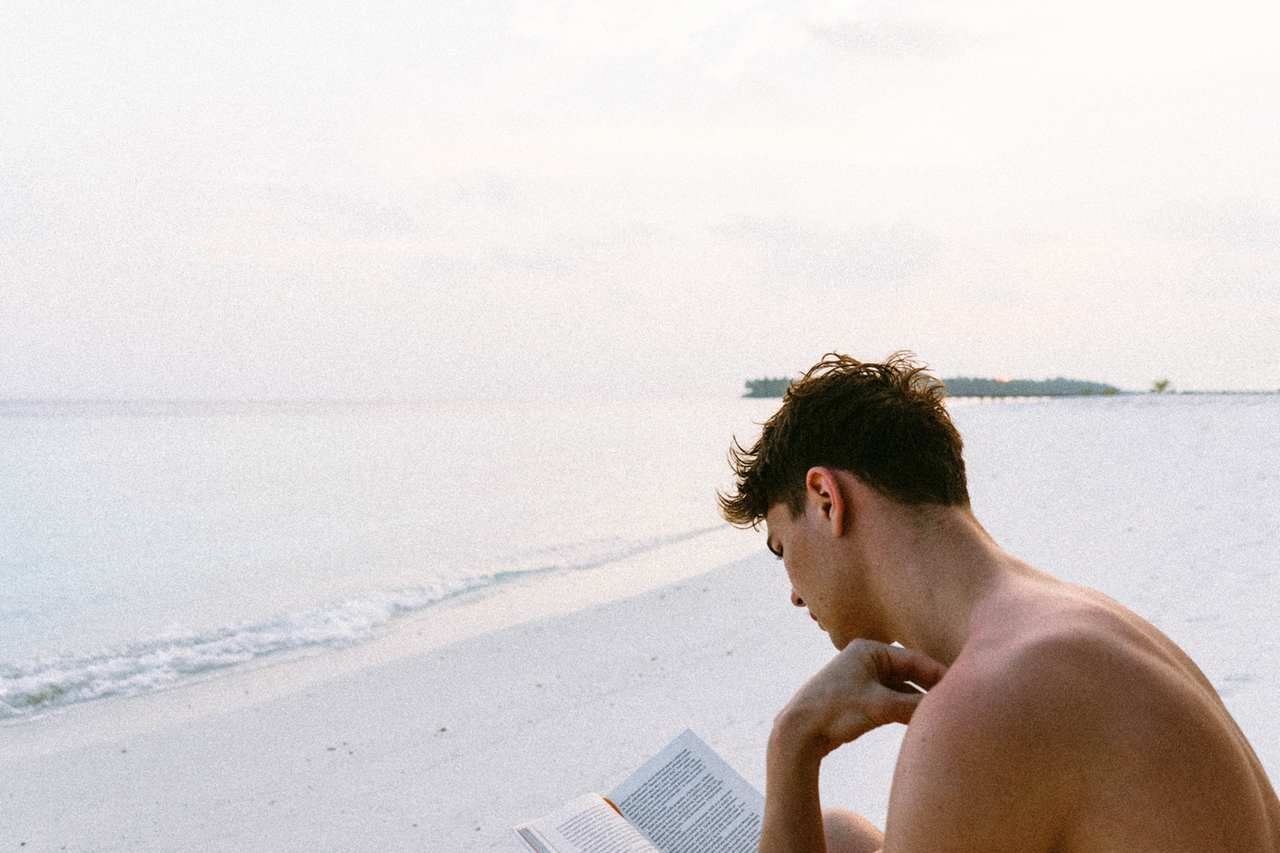 man-reading-book-beach-2018-05-07-01-24