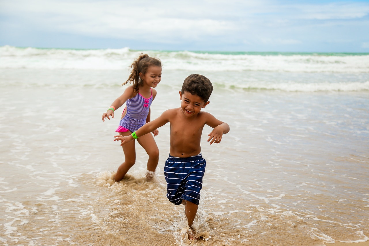 two-kids-having-fun-at-the-beach-2020-04-21-08-33